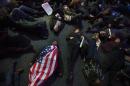 Protesters participate in a "die-in" at Bryant Park during a march against a grand jury's decision not to indict the police officer involved in the death of Eric Garner, Friday, Dec. 5, 2014, in New York. (AP Photo/John Minchillo)