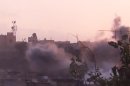 In this image made from amateur video released by the Shaam News Network and accessed Tuesday, June 26, 2012, smoke rises from buildings following purported shelling in Homs, Syria. (AP Photo/Shaam News Network via AP video) TV OUT, THE ASSOCIATED PRESS CANNOT INDEPENDENTLY VERIFY THE CONTENT, DATE, LOCATION OR AUTHENTICITY OF THIS MATERIAL