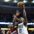 Boston Celtics' Jeff Green (8) shoots over Miami Heat's Shane Battier (31) in the first quarter of an NBA basketball game in Boston, Monday, March 18, 2013. (AP Photo/Michael Dwyer)