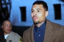 FILE - In this Feb. 3, 2014 file photo, R&B singer Chris Brown arrives at a Los Angeles Superior Court for a probation review hearing in Los Angeles. The Los Angeles Sheriff's Department said that Brown was arrested on an unspecified warrant on Friday, March 14, 2014. The 25-year-old singer remains on probation for his 2009 attack on then-girlfriend Rihanna and has been in court-ordered rehab for several months. (AP Photo/Nick Ut, file)