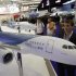 A visitor looks at a model of an Airbus Corporate Jet aircraft during the EBACE at Cointrin airport in Geneva