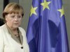 German Chancellor Merkel casts her shadow on EU flag as she arrives for news conference in Berlin