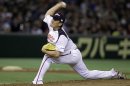 Japan's starter Masahiro Tanaka delivers a pitch against Taiwan in the second inning of their charity baseball game at Tokyo Dome in Tokyo, Saturday, March 10, 2012, on the eve of the anniversary of the March 11 earthquake and tsunami. (AP Photo/Toru Takahashi)