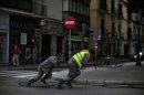 Workers pull optical fiber cable in the Andalusian capital of Seville