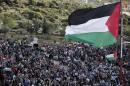 A giant Palestinian flag flutters during a demonstration of Arab-Israelis to mark Land Day on March 30, 2015 in the northern Arab-Israeli village of Deir Hanna