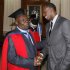 Jamaican sprinter Bolt congratulates his coach Mills after Mills received degree of Doctor Honoris Causa from University of the West Indies in Mona