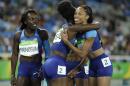 United States' Tianna Bartoletta hugs her teammate Allyson Felix, right, as United States' Morolake Akinosun, left, looks on after a women's 4x100-meter relay after the U.S. team dropped the baton in the morning race during the athletics competitions of the 2016 Summer Olympics at the Olympic stadium in Rio de Janeiro, Brazil, Thursday, Aug. 18, 2016. (AP Photo/Matt Slocum)