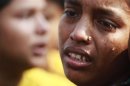 A worker cries during a protest against the death of her colleagues after a devastating fire in a garment factory which killed more than 100 people, in Savar