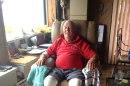 In this handout photo taken Monday, June 10, 2013 and provided by Verian Tuttle, Philip Tuttle sits at his home in Harpswell, Maine recuperating from injuries to his legs. The 90-year-old lobsterman survived the sinking of his boat by swimming to a nearby island through the icy waters of the Gulf of Maine. (AP Photo/Verian Tuttle)