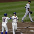 New York Yankees' Andy Pettitte, right, walks back to the pitcher's mound as New York Mets' David Wright (5) celebrates with teammate Ronny Cedeno (13) after they scored on a single by Justin Turner during the first inning of an interleague baseball game on Friday, June 22, 2012, in New York. (AP Photo/Frank Franklin II)