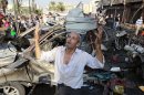 A man recites prayers amid the destruction after a car bomb outside the Al-Taqwa mosque in the northern city of Tripoli, Lebanon, Friday, Aug. 23, 2013. The twin car bombs, which killed dozens hit amid soaring tensions in Lebanon as a result of Syria's civil war, which has sharply polarized the country along sectarian lines and between supporters and opponents of the regime of Syrian President Bashar Assad. It was the second such bombing in just over a week, showing the degree to which the tiny country is being consumed by the raging war next door. (AP Photo/Bilal Hussein)