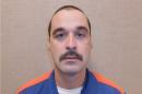 This Feb. 11, 2013 photo provided by the Michigan Department of Corrections shows Michael David Elliot. Elliot, who is serving life behind bars for murder in four 1993 deaths in Michigan, has escaped from prison and may have abducted a woman before she got away in Indiana, according to officials. Michigan Department of Corrections spokesman Russ Marlan says in an email that 40-year-old Elliot was discovered missing about 9:30 p.m. Sunday, Feb. 2, 2014, from the Ionia Correctional Facility in mid-Michigan. (AP Photo/Michigan Department of Corrections)