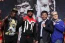 (L-R) Trainer Floyd Mayweather Sr., WBC/WBA welterweight champion Floyd Mayweather Jr., WBO welterweight champion Manny Pacquiao and trainer Freddie Roach pose during a news conference on April 29, 2015 in Las Vegas, Nevada