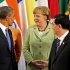President Barack Obama, left, Germany's Chancellor Angela Merkel, center, and China's President Hu Jintao chat while waiting for other leaders to come to the stage to pose for the family photo of the G-20 Summit in Los Cabos, Mexico, Monday, June 18, 2012. (AP Photo/Andres Leighton)