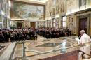 In this photo provided by the Vatican newspaper L'Osservatore Romano, Pope Francis delivers his message to the Patrons of the Arts of the Vatican Museum, a fundraising organization for restoring the Vatican's artistic treasures, on the occasion of their audience, at the Clementine Hall, at the Vatican, Saturday, Oct. 19, 2013. The Patrons celebrated their 30th anniversary with a five-day extravaganza, which included lectures on museum restoration projects, individual chats with Pope Francis, catered dinners in museum galleries, and capped by a private audience with Francis who took time to greet each of the nearly 350 patrons and their families. (AP Photo/L'Osservatore Romano, ho)
