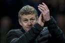 Cardiff City's manager Ole Gunnar Solskjaer applauds supporters after his team's 2-0 loss to Manchester United in their English Premier League soccer match at Old Trafford Stadium, Manchester, England, Tuesday Jan. 28, 2014. (AP Photo/Jon Super)