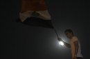Egyptian protester waves the national flag during a demonstration in Cairo