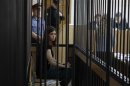 A member of the female punk band "Pussy Riot", Tolokonnikova, looks out from a holding cell as she attends a court hearing to appeal for parole at the Supreme Court of Mordovia in Saransk