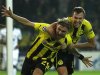 Borussia Dortmund's Schmelzer celebrates with his team mate Grosskreutz after scoring a goal against Real Madrid during their Champions League Group D soccer match at BVB stadium in Dortmund