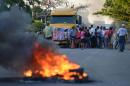 People protest burning tires against the inauguration of the works of an inter-oceanic canal in Rivas, Nicaragua on December 22, 2014