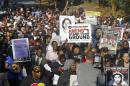 Hundreds of marchers waive their signs as they walk to the Florida Capitol Monday, March 10, 2014, for a rally in Tallahassee, Fla. Participants were rallying against the state's "Stand Your Ground" laws. (AP Photo/Phil Sears)