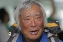 80-year-old Japanese climber Yuichiro Miura, who became the oldest conqueror of Mount Everest on last Thursday, speaks to media upon his arrival at Haneda International Airport in Tokyo, Wednesday, May 29, 2013. Miura, a Japanese former extreme skier, conquered the mountain on May 23 despite undergoing heart surgery in January for an irregular heartbeat, or arrhythmia, his fourth heart operation since 2007. He also broke his pelvis and left thigh bone in a 2009 skiing accident. (AP Photo/Itsuo Inouye)