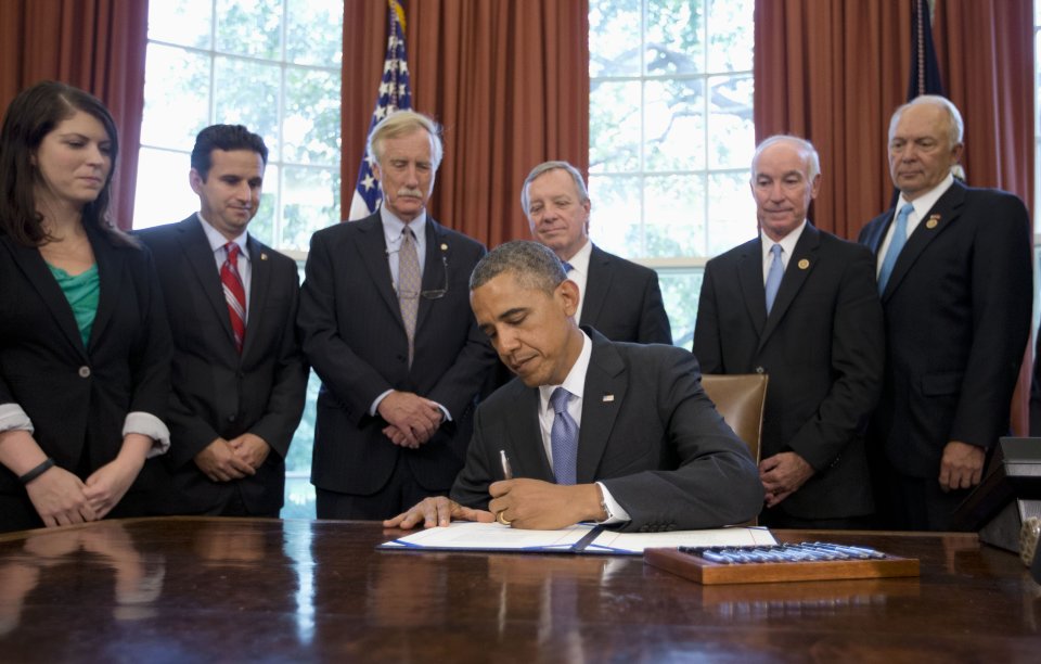 Obama signs student loan deal, says job isn't done