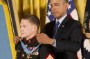 President Barack Obama awards the Medal of Honor to retired Marine Cpl. William "Kyle" Carpenter, Thursday, June 19, 2014, in the East Room of the White House in Washington. Carpenter took a blow from a grenade to protect a fellow Marine in Afghanistan, sustaining major wounds including the loss of his right eye. He is the eighth living recipient to be chosen for the Medal of Honor for actions in Iraq or Afghanistan. (AP Photo/Pablo Martinez Monsivais)