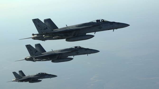A formation of U.S. Navy F-18E Super Hornets leaves after receiving fuel from a KC-135 Stratotanker over northern Iraq