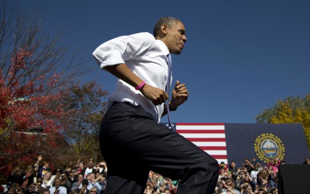 President Barack Obama jogs up the stairs of the stage as he arrives at a campaign event at Veteran's Memorial Park, Thursday, Oct. 18, 2012, in Manchester, N.H. (AP Photo/Carolyn Kaster)