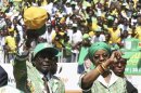 Zimbabwe President Robert Mugabe and his wife Grace arrive to address the final campaign rally of his ZANU-PF party in Harare