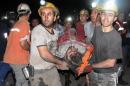 Miners carry a rescued miner after an explosion and fire at a coal mine killed at least 17 miners and left up to 300 workers trapped underground, in Soma, in western Turkey, Tuesday, May 13, 2014. An explosion and fire at the mine killed at least 232 workers, authorities said, in one of the worst mining disasters in Turkish history. Turkey's Energy Minister Taner Yildiz said 787 people were inside the coal mine at the time of the accident. (AP Photo/Depo Photos)
