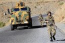 Turkish soldiers patrol a road near Cukurca in the Hakkari province, southeastern Turkey, near the Turkish-Iraqi border