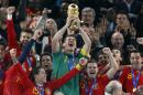 FILE _ This is a file photo of Spain's goalkeeper Iker Casillas, center, as he holds up the World Cup trophy with team members as they celebrate their victory at the end of the World Cup final soccer match between the Netherlands and Spain at Soccer City in Johannesburg, South Africa. Winning the soccer World Cup can bring instant rewards to that country's stock market investors. But they better be quick as the post-victory rally doesn't last long. That's the conclusion of investment bank Goldman Sachs, which published a wide-ranging report late Tuesday May 27, 2014 on the World Cup and its economic impact. Goldman Sachs analysts found 