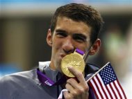 Michael Phelps of the U.S. kisses his 19th Olympic medal presented to him in the men's 4x200m freestyle relay victory ceremony during the London 2012 Olympic Games at the Aquatics Centre July 31, 2012. REUTERS/Michael Dalder