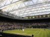 Ivan Ljubicic of Croatia serves to Andy Murray of Britain under the closed roof on Centre Court at the Wimbledon tennis championships in London