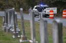 CORRECTS NAME TO HANNAH- Police block the road leading to the scene of a death investigation in connection with the disappearance of University of Virginia student Hannah Graham in Albermarle County, Va., Saturday, Oct. 18, 2014. (AP Photo/Steve Helber)