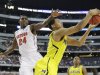 Michigan's Trey Burke (3) grabs a rebound as Florida's Casey Prather (24) defends during the second half of a regional final game in the NCAA college basketball tournament, Sunday, March 31, 2013, in Arlington, Texas. (AP Photo/David J. Phillip)