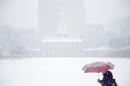 A woman walks past Independence Hall during a winter snowstorm Tuesday, Dec. 10, 2013, in Philadelphia. Accumulations of 3 to 6 inches were expected as the National Weather Service issued a winter storm warning for the Eastern Seaboard, including Baltimore, Washington, D.C., Philadelphia and Wilmington, Del. (AP Photo/Matt Rourke)