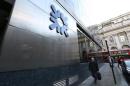 A man walks past a Royal Bank of Scotland building in central London