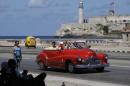 FILE - In this Oct 12, 2013 file photo, tourists ride in a classic American car on the Malecon in Havana, Cuba. A new set of U.S. government regulations takes effect Friday, Jan. 16, 2015, severely loosening the 50-decade long travel and trade restrictions for Cuba. (AP Photo/Franklin Reyes, File)