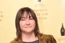 Scottish author Ali Smith holds her book 'How to be Both' as she poses at a photocall for the 2015 Baileys Women's Prize for Fiction in London on June 3, 2015
