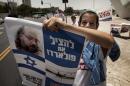 An Israeli youth holds a picture of Jonathan Pollard, during a demonstration for his release in Jerusalem on July 13, 2010