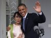 FILE - In this Nov. 19, 2012 file photo, U.S. President Barack Obama waves to the media as he embraces Myanmar opposition leader Aung San Suu Kyi after they spoke to the media at her residence in Yangon, Myanmar, Monday. The United States is unwinding two decades of sanctions against Myanmar, as the country's reformist leadership oversees rapid-fire economic and political change. Obama's visit this week, the first by a serving U.S. president, is a sign of how far relations have come. But Washington continues to take a calibrated approach to easing sanctions, keen to retain leverage should Myanmar's reform momentum stall. (AP Photo/Khin Maung Win, Pool, File)