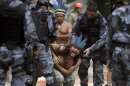 A native Indian reacts as military police officers evict a native Indian community living at the Brazilian Indian Museum in Rio de Janeiro