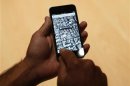 A member of the media uses the map function of iPhone 5 after its introduction during Apple Inc.'s iPhone media event in San Francisco