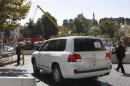 U.N. vehicles transporting a team of OPCW experts, leave their hotel in Damascus