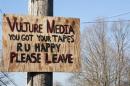 A sign expressing displeasure with the media is tacked on a pole in Newtown