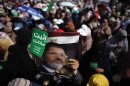 A supporter of deposed Egyptian President Mursi holds up his poster during a march from Raba El-Adwyia square to the Republican Guards headquarters in Cairo