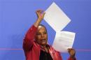 French Justice Minister Taubira holds copies of the wiretapping memos during a news conference at the Elysee Palace in Paris